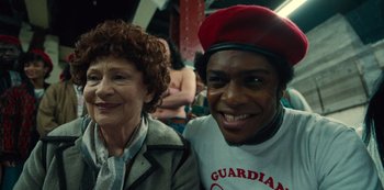 Movie still from “Russian Doll” (2019), created by Natasha Lyonne – A man and a woman smiling for the camera; Close Up shot, Over the shoulder angle