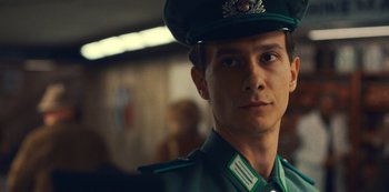 Movie still from “Russian Doll” (2019), created by Natasha Lyonne – A man in a uniform is looking at the camera; Close Up shot, Over the shoulder angle