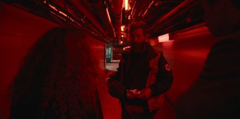 Movie still from “Russian Doll” (2019), created by Natasha Lyonne – A man holding a game controller in a dark room; Medium shot, Over the shoulder angle