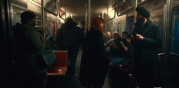Movie still from “Russian Doll” (2019), created by Natasha Lyonne – A group of people sitting on a subway train; Wide shot, High angle