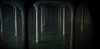 Movie still from “Russian Doll” (2019), created by Natasha Lyonne – A man standing in the middle of a body of water surrounded by pillars; Extreme Wide shot, High angle