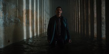 Movie still from “Russian Doll” (2019), created by Natasha Lyonne – A man standing in the middle of a flooded area; Wide shot, High angle