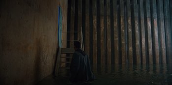 Movie still from “Russian Doll” (2019), created by Natasha Lyonne – A man sitting on the steps of a building; Extreme Wide shot, High angle