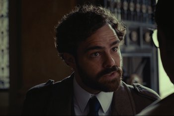 Movie still from “Argentina, 1985” (2022), directed by Santiago Mitre – A person wearing a suit and tie; Close Up shot, Over the shoulder angle