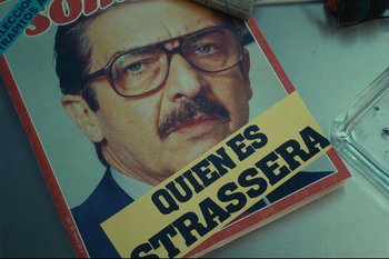 Movie still from “Argentina, 1985” (2022), directed by Santiago Mitre – A magazine with a picture of a man wearing glasses and a hat; Extreme Close Up shot, Low angle