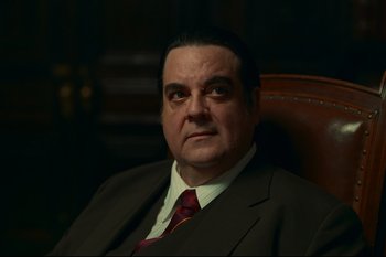 Movie still from “Argentina, 1985” (2022), directed by Santiago Mitre – A person wearing a suit and tie; Close Up shot, Low angle