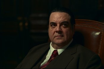 Movie still from “Argentina, 1985” (2022), directed by Santiago Mitre – A person wearing a suit and tie; Close Up shot, Low angle