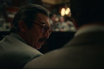 Movie still from “Argentina, 1985” (2022), directed by Santiago Mitre – An older man wearing glasses and a suit; Close Up shot, Over the shoulder angle