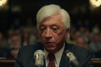 Movie still from “Argentina, 1985” (2022), directed by Santiago Mitre – An older man with white hair is speaking at an event; Close Up shot, Over the shoulder angle