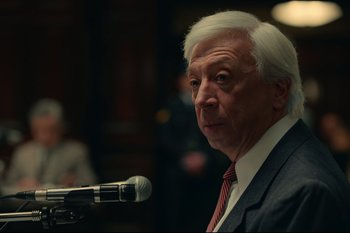 Movie still from “Argentina, 1985” (2022), directed by Santiago Mitre – An older man is speaking at a microphone; Close Up shot, Over the shoulder angle