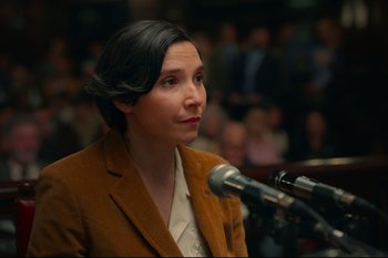 Movie still from “Argentina, 1985” (2022), directed by Santiago Mitre – A woman is speaking at a microphone in front of a crowd; Close Up shot, Over the shoulder angle
