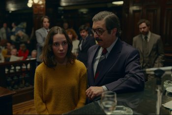 Movie still from “Argentina, 1985” (2022), directed by Santiago Mitre – A man and a woman standing next to each other in a bar; Medium shot, Over the shoulder angle