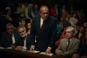 Movie still from “Argentina, 1985” (2022), directed by Santiago Mitre – A man standing in front of other men in a courtroom; Medium shot, Low angle