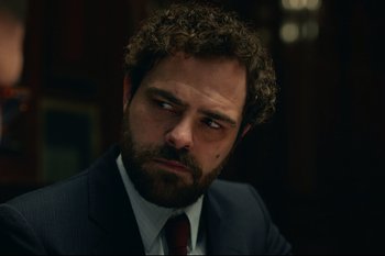 Movie still from “Argentina, 1985” (2022), directed by Santiago Mitre – A person wearing a suit and tie; Close Up shot, Over the shoulder angle