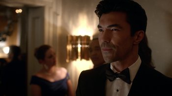 Movie still from “Salvation” (2017), created by Elizabeth Kruger – A man in a tuxedo standing in front of a woman; Close Up shot, Over the shoulder angle
