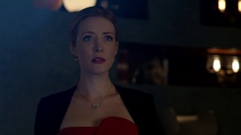 Movie still from “Salvation” (2017), created by Elizabeth Kruger – A woman in a red dress and a black jacket; Close Up shot, Over the shoulder angle