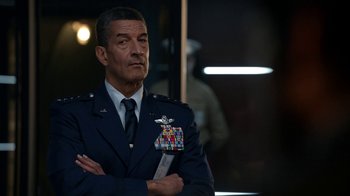 Movie still from “Salvation” (2017), created by Elizabeth Kruger – A man in a military uniform with his arms crossed; Close Up shot, Low angle