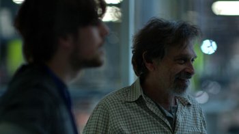 Movie still from “Salvation” (2017), created by Elizabeth Kruger – A man with a gray beard and a man with long hair; Close Up shot, Over the shoulder angle
