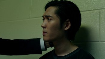 Movie still from “Salvation” (2017), created by Elizabeth Kruger – A young man with his hand on his shoulder; Close Up shot, Over the shoulder angle