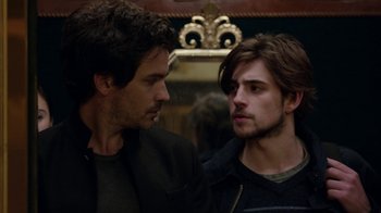 Movie still from “Salvation” (2017), created by Elizabeth Kruger – Two young men standing next to each other in front of a mirror; Close Up shot, Over the shoulder angle