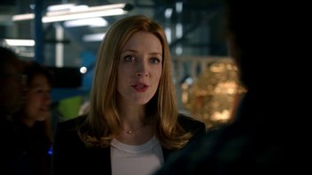 Movie still from “Salvation” (2017), created by Elizabeth Kruger – A person wearing a suit and tie; Close Up shot, Over the shoulder angle