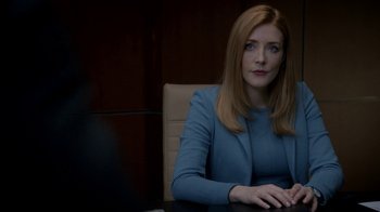 Movie still from “Salvation” (2017), created by Elizabeth Kruger – A woman sitting at a table in a room; Close Up shot, Over the shoulder angle