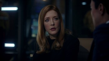 Movie still from “Salvation” (2017), created by Elizabeth Kruger – A woman sitting in front of a window at night; Close Up shot, Over the shoulder angle