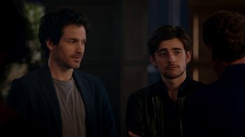Movie still from “Salvation” (2017), created by Elizabeth Kruger – Two men standing next to each other in the dark; Close Up shot, Over the shoulder angle