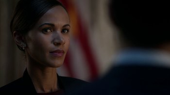 Movie still from “Salvation” (2017), created by Elizabeth Kruger – A person wearing a suit and tie; Close Up shot, Over the shoulder angle