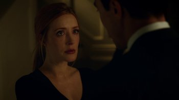 Movie still from “Salvation” (2017), created by Elizabeth Kruger – A woman in a black dress looking at a man in a black suit; Close Up shot, Over the shoulder angle