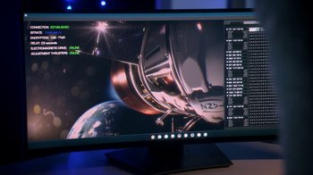 Movie still from “Salvation” (2017), created by Elizabeth Kruger – A computer monitor with a picture of a space station on it; Extreme Close Up shot, High angle