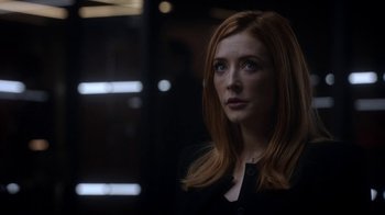 Movie still from “Salvation” (2017), created by Elizabeth Kruger – A woman with long red hair is looking into the distance; Close Up shot, Over the shoulder angle