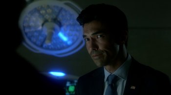 Movie still from “Salvation” (2017), created by Elizabeth Kruger – A person wearing a suit and tie; Close Up shot, Over the shoulder angle