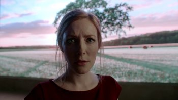 Movie still from “Salvation” (2017), created by Elizabeth Kruger – A person looking at the camera; Close Up shot, Low angle