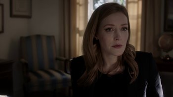 Movie still from “Salvation” (2017), created by Elizabeth Kruger – A woman sitting in front of a window in a living room; Close Up shot, Over the shoulder angle