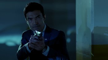 Movie still from “Salvation” (2017), created by Elizabeth Kruger – A man in a suit holding a cell phone in his hand; Close Up shot, Over the shoulder angle