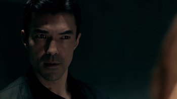 Movie still from “Salvation” (2017), created by Elizabeth Kruger – A person wearing a black shirt; Close Up shot, Over the shoulder angle