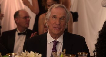 Movie still from “Sandy Wexler” (2017), directed by Steven Brill – An older man sitting at a dinner table; Close Up shot, Over the shoulder angle