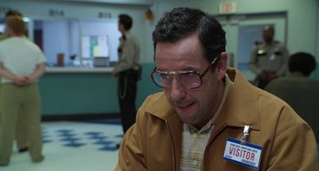 Movie still from “Sandy Wexler” (2017), directed by Steven Brill – A man with glasses is sitting in a waiting room; Close Up shot, Over the shoulder angle