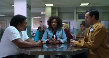 Movie still from “Sandy Wexler” (2017), directed by Steven Brill – A group of people sitting around a table; Medium shot, High angle