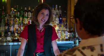 Movie still from “Sandy Wexler” (2017), directed by Steven Brill – A woman sitting at a bar talking to a man; Close Up shot, Over the shoulder angle