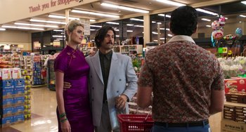 Movie still from “Sandy Wexler” (2017), directed by Steven Brill – A man and a woman standing next to each other in a store; Medium shot, Over the shoulder angle