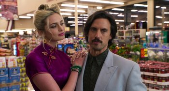 Movie still from “Sandy Wexler” (2017), directed by Steven Brill – A man and a woman posing for a picture in a store; Close Up shot, Over the shoulder angle