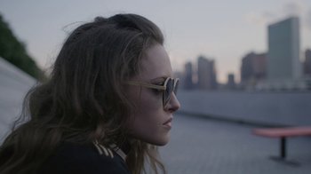 Movie still from “Mr. Robot” (2015), created by Sam Esmail – A woman wearing sunglasses looking off into the distance; Close Up shot, High angle