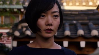 Movie still from “Sense8” (2015), directed by Tom Tykwer – A person with short black hair; Close Up shot, Over the shoulder angle
