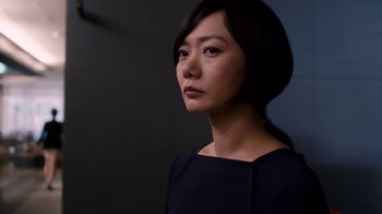 Movie still from “Sense8” (2015), directed by Tom Tykwer – A woman in a black dress is looking to her left; Close Up shot, Low angle