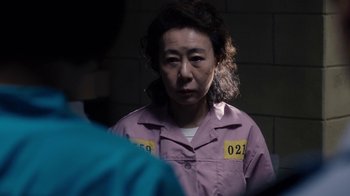 Movie still from “Sense8” (2015), directed by Tom Tykwer – A woman in a purple shirt is looking at the camera; Close Up shot, Over the shoulder angle