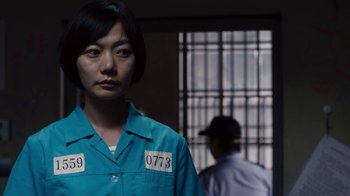 Movie still from “Sense8” (2015), directed by Tom Tykwer – A woman standing in front of a jail cell; Close Up shot, Low angle