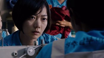 Movie still from “Sense8” (2015), directed by Tom Tykwer – A young asian woman looking at the camera; Close Up shot, Over the shoulder angle