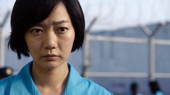 Movie still from “Sense8” (2015), directed by Tom Tykwer – A person wearing a blue shirt; Close Up shot, Low angle